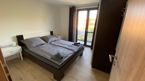 a bedroom with a bed and a door with a window at VILLA HOLIDAY in Banjole