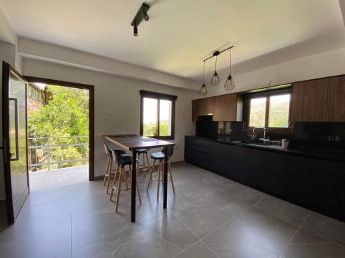 a kitchen with a table and chairs in a room at Maria's Apartments 1 in Galata