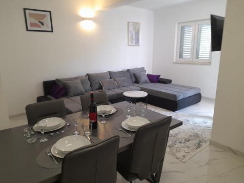a living room with a table and a couch at Lavanda Apartments in Sveti Petar