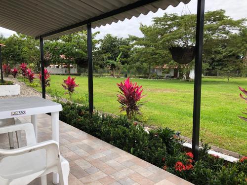 a patio with a table and chairs in a park at Cabañas Campestres en Villavicencio in Villavicencio