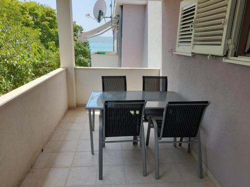 a table and chairs on a balcony with a view of the ocean at Lavanda Apartments in Sveti Petar