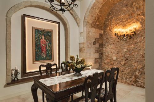 a dining room with a table and a painting on the wall at Nobili Boutique Hotel in Chania Town