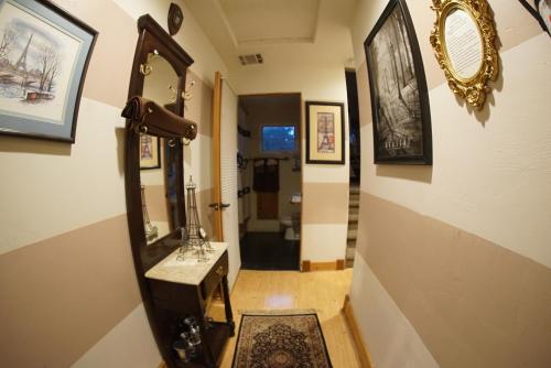 a hallway with a mirror and a sink in a room at FLEUR DE LAC EUROPERAN INn in Lake Arrowhead