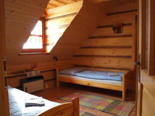 a room with a bed in a log cabin at Chalupa Gita in Osturňa