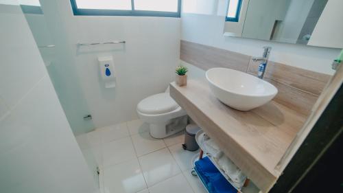 a bathroom with a sink and a toilet at La Iguana de Santa Fe by Bernalo Hotels in Santa Fe de Antioquia