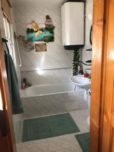 a bathroom with a bath tub and a sink at Chalupa Gita in Osturňa
