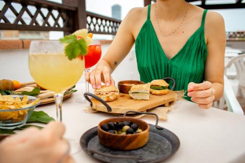 a woman sitting at a table with a tray of food at New Bristol Sport Hotel in Cesenatico