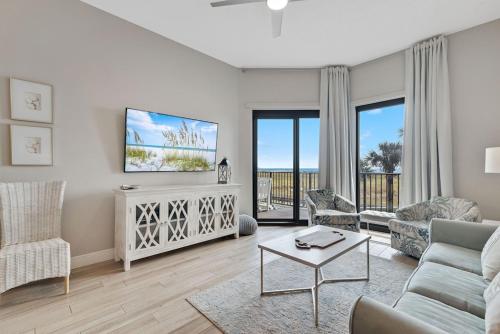 a living room with a couch and a tv at Phoenix 6 Unit 114 in Orange Beach