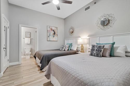 a bedroom with two beds and a ceiling fan at Phoenix 6 Unit 114 in Orange Beach