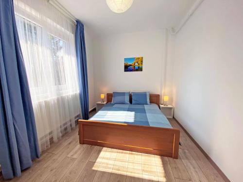 ein Schlafzimmer mit einem Bett und einem großen Fenster in der Unterkunft Vizililiom Vendégház in Tiszafüred
