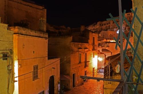 a view of a city at night at ENOTRIO Barisano in Matera
