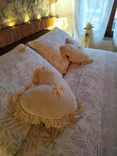 a bed with two pillows on top of it at Bed And Breakfast Olimpia in San Salvatore Monferrato
