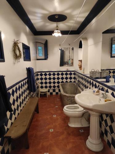 a bathroom with a sink and a toilet and a sink at CASA DE INDIANoS, UNA EXPERIENCIA UNICA EN EL CENTRO DE CANTABRIA in San Vicente de Toranzo