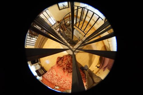 a person is looking up at a spiral staircase at FLEUR DE LAC EUROPERAN INn in Lake Arrowhead