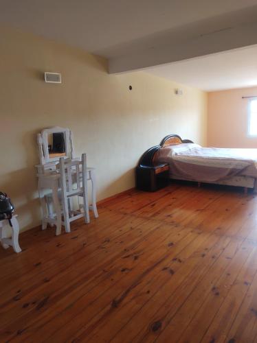 a bedroom with a bed and a table and a chair at Departamento 1 ambiente zona sur in Rafael Calzada