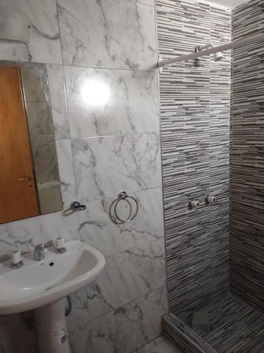 a bathroom with a sink and a shower at Departamento 1 ambiente zona sur in Rafael Calzada