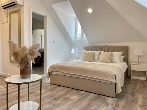 a bedroom with a large bed and a table at Ida Old Town Rooms 2 in Dubrovnik