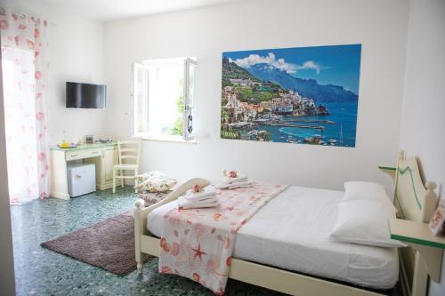 una camera da letto con un letto e un quadro sul muro di IL CEPPO sui sentieri per Amalfi a Pimonte