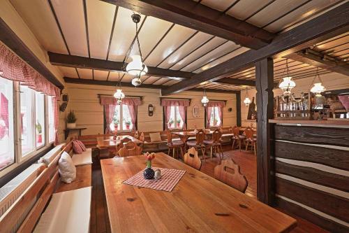 een eetkamer met een houten tafel en stoelen bij Penzion a Restaurace U Paseků in Harrachov