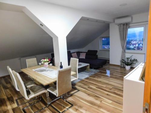 a dining room and living room with a table and chairs at Apartman Lara in Otočac