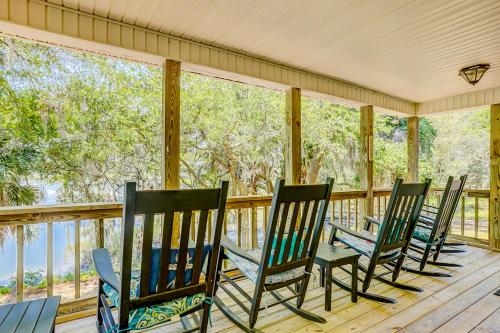 a row of rocking chairs on a screened porch at In Spite of Ourselves in Edisto Beach
