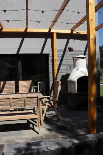 a patio with two chairs and a table and a grill at Domek Lubkowo ,, Porto di Verde ’’Kaszuby, blisko morze, Dębki 8km in Lubkowo