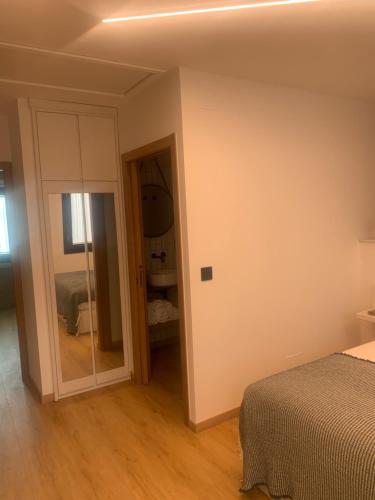 a bedroom with a bed and a mirror at Mar De Muros in Muros