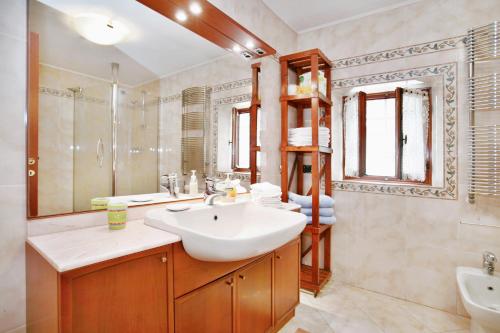 a bathroom with a sink and a mirror at Villa Camilla - WIDE - EXCLUSIVE POOL in Lucca