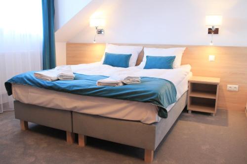 a large bed in a room with towels on it at Perła Dunajca Zakliczyn in Zakliczyn