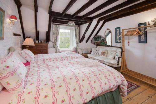 a bedroom with a large bed and a window at Strone House in Helensburgh