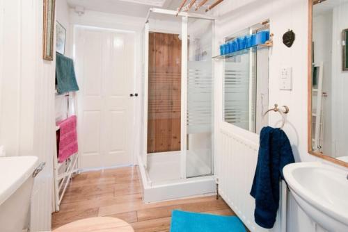 a bathroom with a shower and a sink at Strone House in Helensburgh