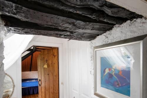 a room with a ceiling with a painting and a door at Strone House in Helensburgh