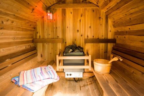an inside of a wooden cabin with a wooden tub at Strone House in Helensburgh