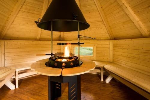 a room with a fireplace in a log cabin at Strone House in Helensburgh