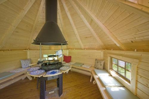 a living room of a log cabin with a large ceiling at Strone House in Helensburgh