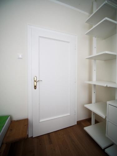 a white door in a room with shelves at Haus an der Lieser in Spittal an der Drau