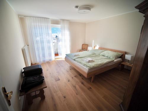 a bedroom with a bed and a large window at Haus an der Lieser in Spittal an der Drau