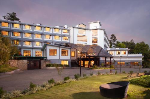 a large white building with a lot of windows at Sterling Munnar in Munnar