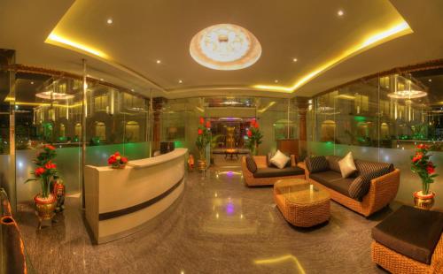 a lobby of a hotel with couches and chairs at Jal Mahal Resort and Spa in Mysore