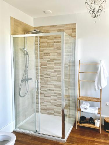 a shower with a glass door in a bathroom at Demeure de la Garenne in Montmirail