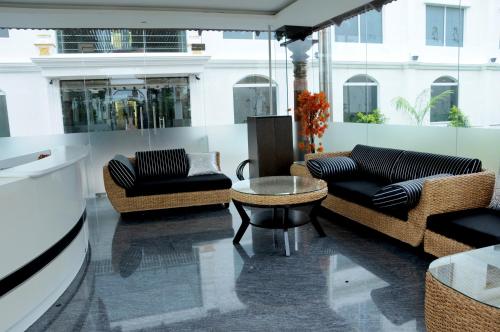 a living room with two couches and a table at Jal Mahal Resort and Spa in Mysore