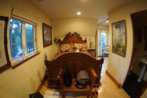 a bedroom with a large wooden bed in a room at FLEUR DE LAC EUROPERAN INn in Lake Arrowhead