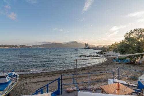 a view of a beach with boats on the water at Kanava seafront apartment I in Zefiría