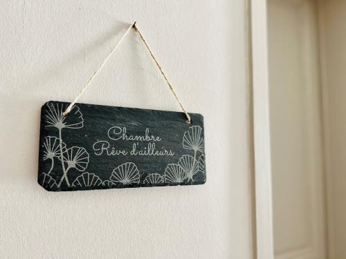 a chalkboard sign hanging on a wall at Demeure de la Garenne in Montmirail