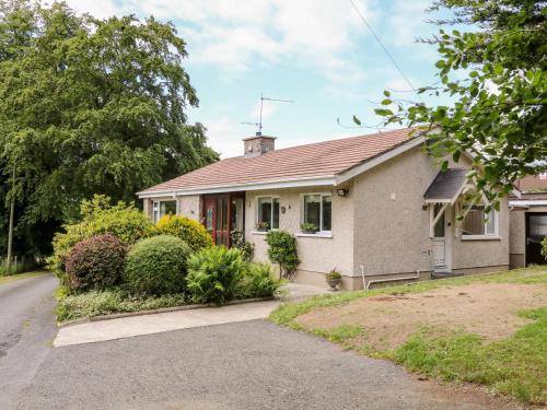 a white house with a red roof at Glebe Farm Cottage in Newry