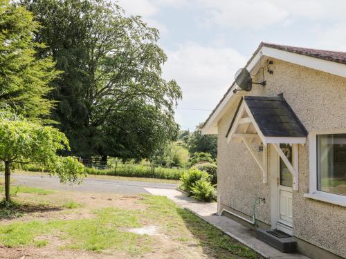 a house with a solar roof on a road at Glebe Farm Cottage in Newry