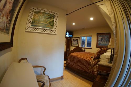 a hallway leading to a bedroom with a bed at FLEUR DE LAC EUROPERAN INn in Lake Arrowhead