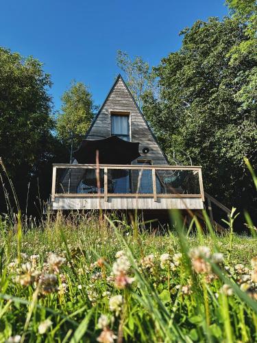 a house with a deck in the middle of a field at Demeure de la Garenne in Montmirail