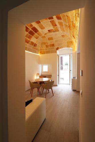 a living room with a stone ceiling and a table at IL GELSO BIANCO Luxury apartments in Polignano a Mare