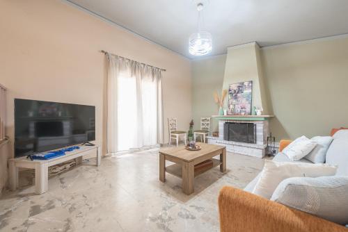 a living room with a couch and a tv at Castle's Nest 1 in Kástro Tornéze